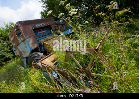 Abandoned Farm machinery is left to rust in overgrown fields near Droitwich, Worcestershire Stock Photo