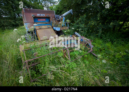 Abandoned Farm machinery is left to rust in overgrown fields near Droitwich, Worcestershire Stock Photo