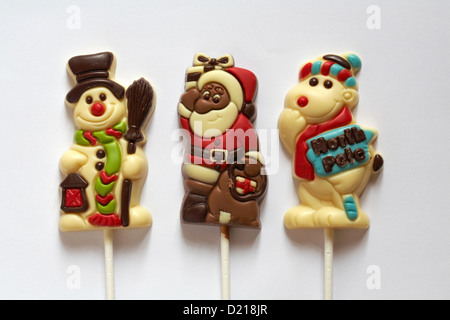 three chocolate lollies - snowman, North Pole polar bear and Father Christmas ready for Christmas on white background Stock Photo