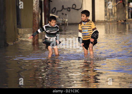 Jan. 10, 2013 - Gaza City, Gaza Strip, Palestinian Territory - Palestinians children walk in a flooded street after a torrential rains.  (Credit Image: © Sameh Rahmi/APA Images/ZUMAPRESS.com) Stock Photo