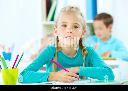 Portrait of a cute girl doing tasks at school Stock Photo