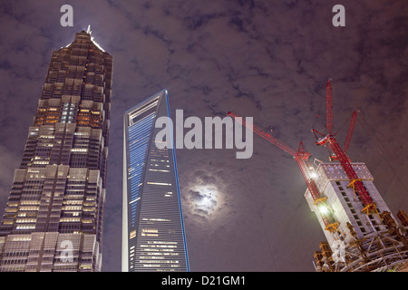 Construction site of Shanghai Tower next to Shanghai World Financial Center and Jin Mao Tower at night, Pudong, Shanghai, China, Stock Photo