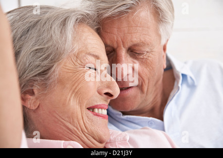 Spain, Senior couple relaxing in hotel, smiling Stock Photo