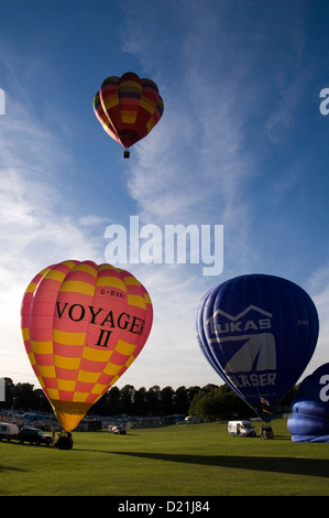 Three balloons taking off at the Northampton balloon festival. Stock Photo