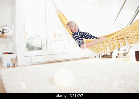 Germany, Bavaria, Munich, Woman relaxing in hammock Stock Photo