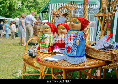 Handmade stuffed dolls on display at a fair for sale during the annual Intl festival of music and crafts World of Siberia. Stock Photo
