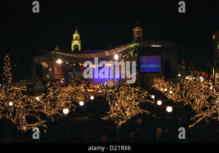 Trees decorated with light strings on Christmas eve in front of the Church of Nativity at Manger square in the West Bank town of Bethlehem Palestinian territories Israel Stock Photo