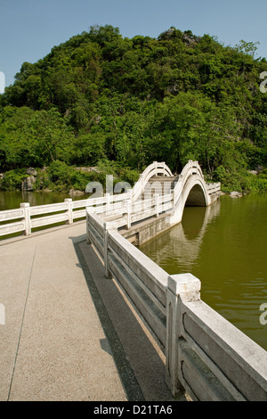 The bridge across the western lake in Xishan Park in Guilin city in Guangxi Province in China. Stock Photo