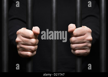 Prisoner Behind Bars. Close Up. Stock Photo
