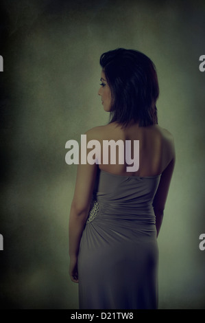 Rear view of a young woman looking away Stock Photo