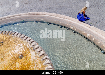Girl by a water fountain Piazza del Popolo Rome Italy Stock Photo