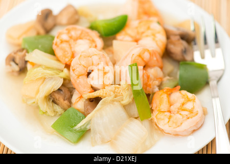 Close-up on a Chinese meal of mixed vegetables and prawns - studio shot with a shallow depth of field. Stock Photo