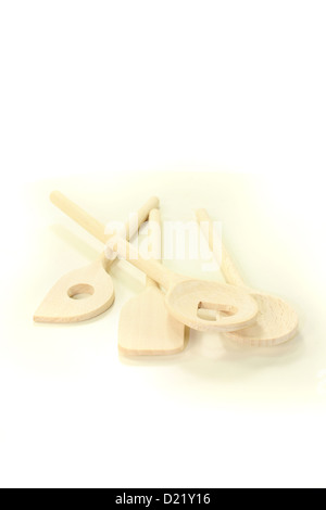 four light wooden cooking spoon on a bright background Stock Photo