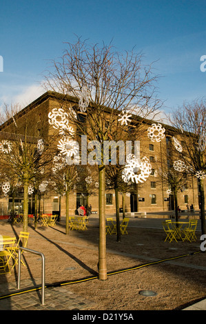 Outdoor tree decorated for Christmas with cut of snowflakes The Grannery Building University of the Arts Central Saint Martins
