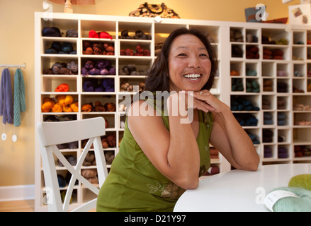 Asian American woman portrait in fabric store Stock Photo
