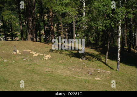 Sunny green grass pine trees view two graves, Chinese Section Mount Moriah Cemetery, Deadwood, South Dakota, USA Stock Photo