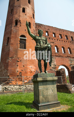 A statue of Caesar Augustus in front of the Palatine Gate that is part of Roman ruins in Turin Italy that date back to 25BC. Stock Photo