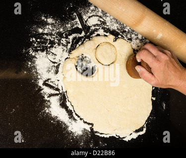 Baker cutting biscuit blanks from dough Stock Photo