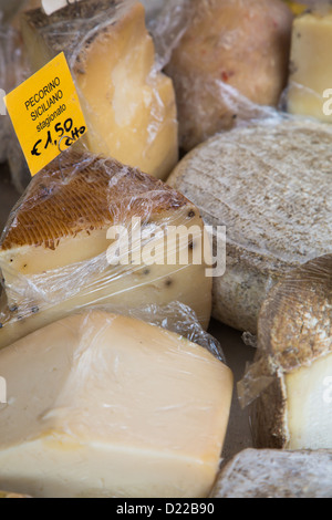 A variety of cheeses on display at the Saturday morning market in Alba in the Piedmont region of Italy Stock Photo