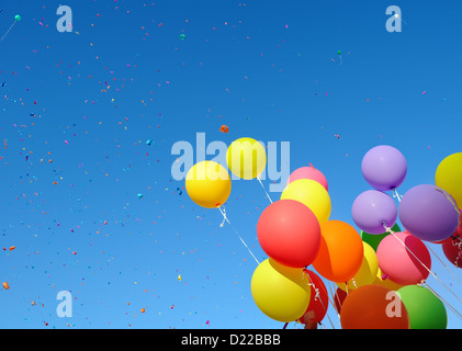 multicolored balloons and confetti in the city festival Stock Photo