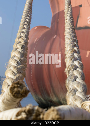ropes on the Bulbous bow of dry cargo ship docked in harbor Stock Photo