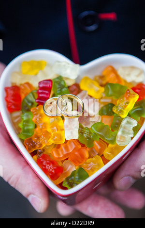 Wedding rings on a bunch of gummy bears Stock Photo