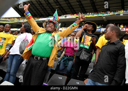 DURBAN - 12 January 2013 - Supporters of South African president Jacob Zuma cheer as he arrives at Durban's Kings Park Stadium for the ruling African National Congress party's 101st anniversary celebrations. Picture: APP/Alamy Stock Photo