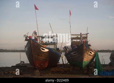 Vietnamese fishing boats sit perched on the dry dock at Duy Hai Fishing Village in Hoi An Stock Photo