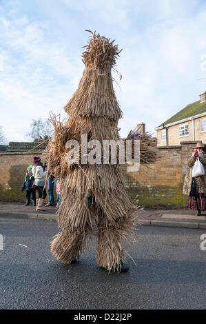 A performer  dressed as a Straw Bear parades around the Fenland town of Whittlesey near Peterborough UK Saturday 12th January 2013. Over 250 folk dancers and musicians follow the bear in a festival that started in the 1800's and was revived in 1980, traditionally held in January. The parade was followed by dancing, drinking and eating around the town.  Credit:  Julian Eales / Alamy Live News Stock Photo