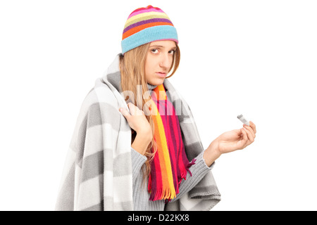 Young woman with flu holding a thermometer isolated on white background Stock Photo