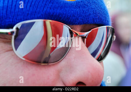 The Union Flag is reflected in sunglasses worn by one of over 600 unionist protesters gathered outside Belfast City Hall for the weekly protest against the removal of the Union Flag.  Unionists are angry that the flag will only be flown on designated days. Stock Photo
