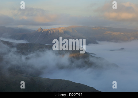 View from the summit of Wetherlam over a temperature inversion towards the Langdale Pikes in the English Lake District Stock Photo