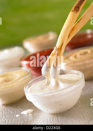 French fries dipping into ranch dressing Stock Photo
