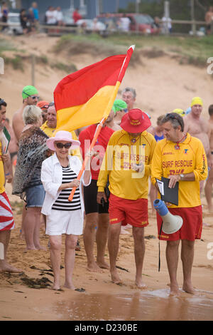 Sydney, Australia. 13th Jan, 2013. The Avalon Beach 1.5km ocean swim race, part of the pittwater ocean swim series of events, Avalon Beach, Sydney,Australia. Local federal MP Ms Bronwyn Bishop holds the starters flag prior to the swim race getting underway Stock Photo