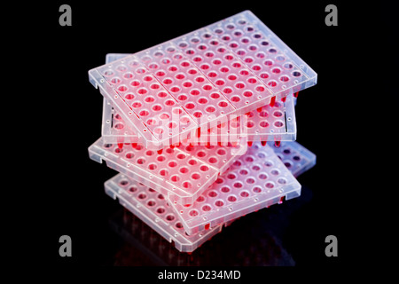 96 well plates on lab table with red liquid samples Stock Photo