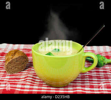 Green Cream broccoli steaming soup.Vegetables around the bowl Stock Photo
