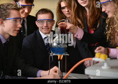 Head Master Russel Ellicott with pupils conducting a chemistry experiment during a science lesson at Pates Grammar School in Che Stock Photo