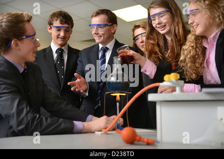Head Master Russel Ellicott with pupils conducting a chemistry experiment during a science lesson at Pates Grammar School in Che Stock Photo