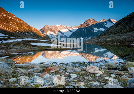 Mountain panorama from Maerjelensee in early morning with Fusshorn and Dreieckshorn. Part of the Jungfrau-Aletsch UNESCO World H Stock Photo