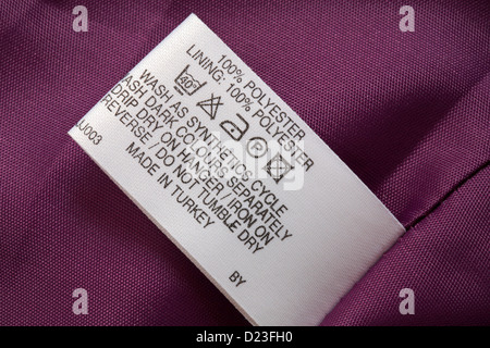 label in jacket 100% polyester Made in Turkey - sold in the UK United Kingdom, Great Britain - care washing symbols and instructions Stock Photo