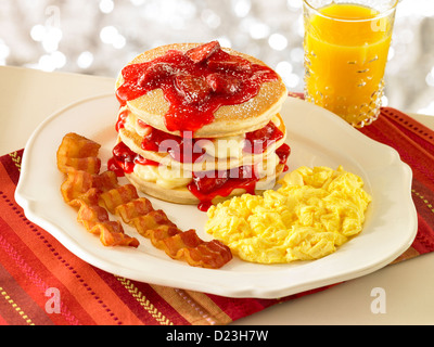 Strawberry stuffed pancake stack with orange juice Stock Photo