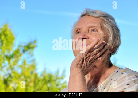Senior woman looking on sky and smilling. Stock Photo