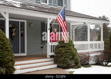 Mature Man At Suburban Home Front Door Porch USA Stock Photo