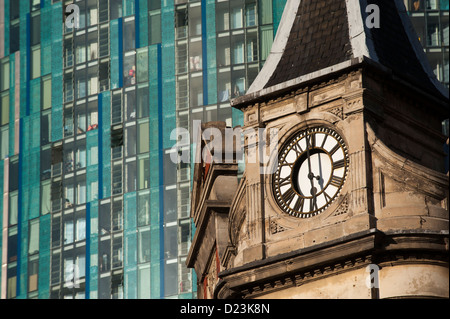 The old and the new. A 19th century clock tower is overshadowed by the Radisson SAS Hotel in Birmingham City Centre Stock Photo