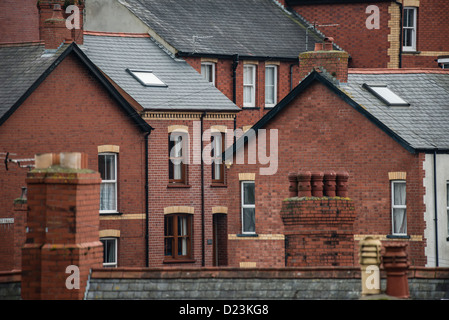 A compressed together group of traditionally built owner occupied red brick terraced houses, UK Stock Photo