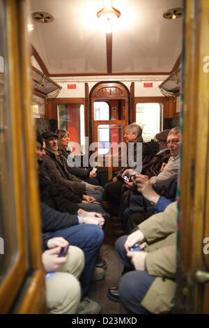 Moorgate Underground Station, London, UK. 13th Jan, 2013. Picture shows train enthusiasts sat in on of the victorian carriages on the Moorgate Station platform at the 150th Anniversary of the first underground railway when the initial journey took place in 1863. The first journey has been recreated using a restored locomotive and an old Metropolitan rail carriage from Paddington to Farringdon. Stock Photo