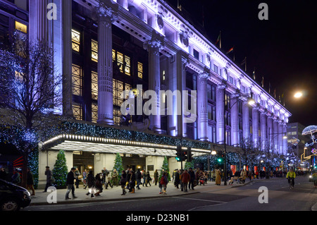 Famous colonnade facade & entrance of Selfridges department store retail business with decorations & Christmas lights Oxford Street London England UK Stock Photo