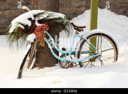 An old pink bike left chained up in the snow. Stock Photo