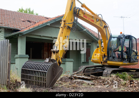 Demolition contractor begins work on a 1920s 'Californian Bungalow' timber home in suburban Melbourne, Australia Stock Photo