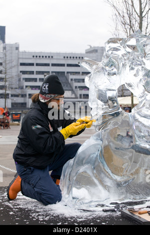 Man sculpting ice with chisel Ice Sculpting Festival Canary Wharf ...